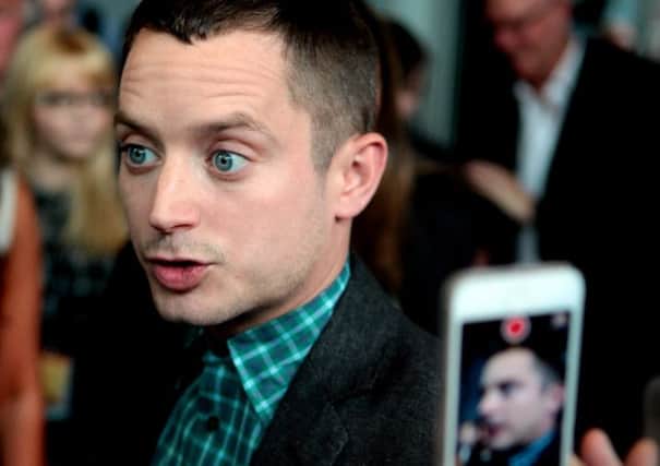 A fan snatches a photo of Elijah Wood on the red carpet at the premiere of his new film in Edinburgh. Picture: Hemedia