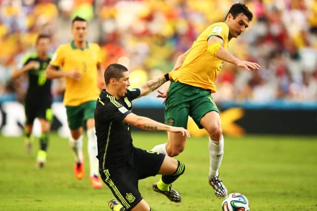 Fernando Torres of Spain is challenged by Mile Jedinak of Australia. Picture: Getty