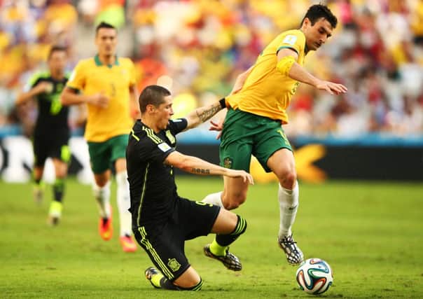 Fernando Torres of Spain is challenged by Mile Jedinak of Australia. Picture: Getty