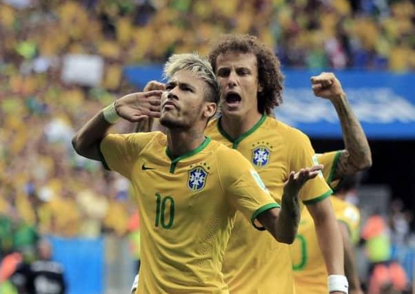 Neymar takes the acclaim of the home support and team-mate David Luiz after his opener last night. Picture: Getty