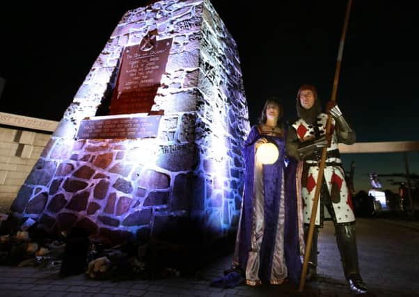 Robert and Gillian Ballantyne take part in a torchlight procession to commemorate the Battle of Bannockburn. Picture: Andrew Milligan/PA