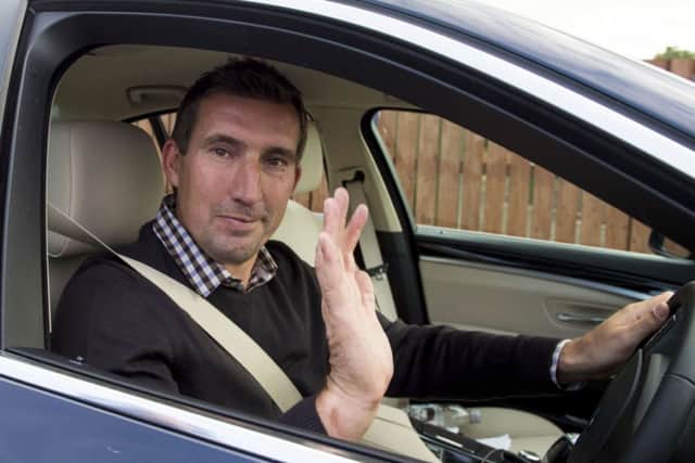 Alan Stubbs waves as he leaves the Hibernian training centre at East Mains. Picture: SNS