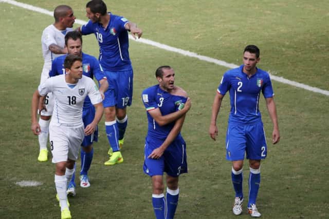 Italy's Giorgio Chiellini shows his shoulder, claiming he was bitten by Uruguay's Luis Suarez. Picture: Reuters