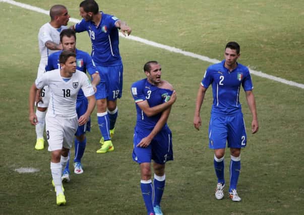 Italy's Giorgio Chiellini shows his shoulder, claiming he was bitten by Uruguay's Luis Suarez. Picture: Reuters