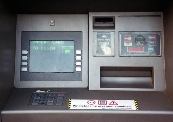 Police in Edinburgh are hunting two people in relation to card skimming devices found in city centre ATMs. Picture: PA