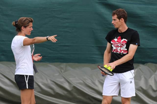 Andy Murray, right, discusses tactics with new coach Amelie Mauresmo ahead of his second-round tie. Picture: PA