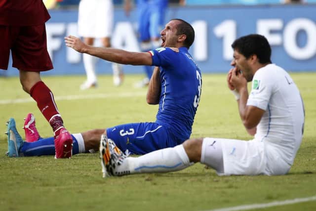 Luis Suarez, right, has been banned from playing football for four months. Picture: Reuters