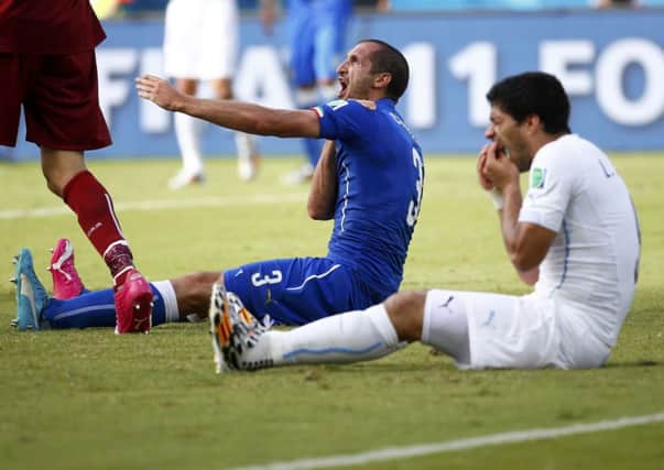 Luis Suarez, right, has been banned from playing football for four months. Picture: Reuters