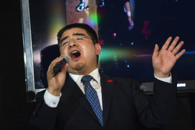 Chen Guangbiao sang We Are the World and performed magic tricks, but could not win over the homeless people. Picture: Reuters
