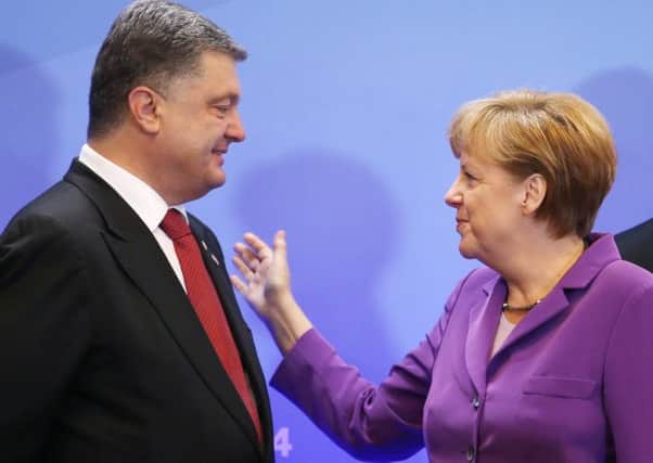 Petro Poroshenko, in Brussels with German chancellor Angela Merkel. Picture: Reuters