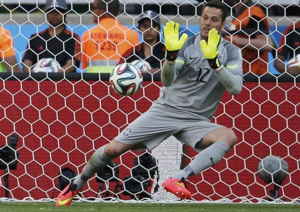 Brazil's Julio Cesar saving a penalty during  the shootout. Picture: Reuters