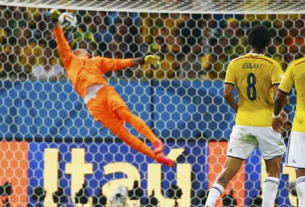 Uruguay's goalkeeper Fernando Muslera is powerless to stops Colombia's James Rodríguez's spectacular volley. Picture: Reuters