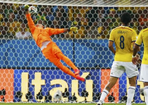 Uruguay's goalkeeper Fernando Muslera is powerless to stops Colombia's James Rodríguez's spectacular volley. Picture: Reuters