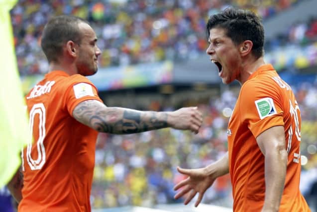 Huntelaar, right, celebrates with Wesley Sneijder after slotting home the late penalty. Picture: AP