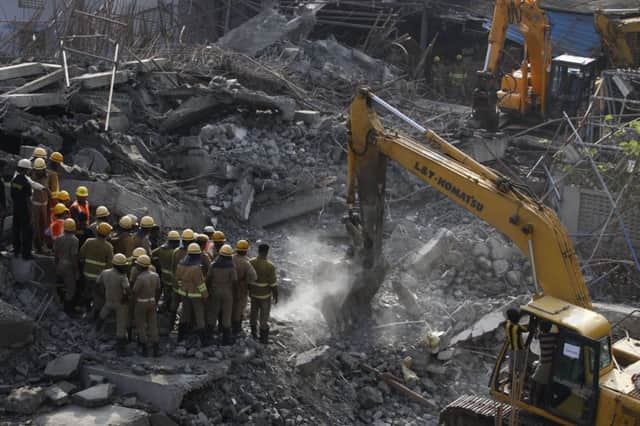 Rescuers search for survivors following the collapse of a building in Chennai, India, late on Saturday. Picture: AP Photo