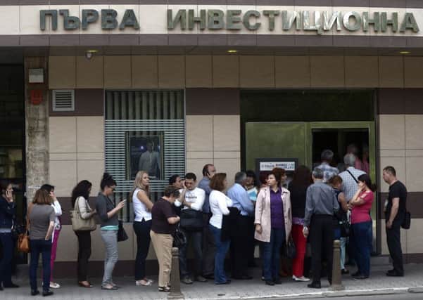People queue in front of a branch of Bulgaria's First Investment Bank in Sofia. Picture: Getty