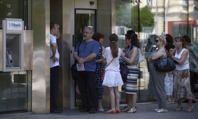 People queue up in front of an office of Bulgarias First Investment Bank. Picture: Getty
