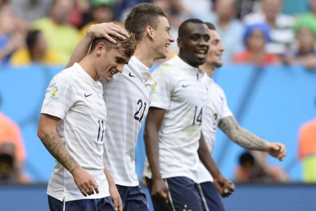 Antoine Griezmann, left, celebrates with defender Laurent Koscielny  and midfielder Blaise Matuidi. Picture: Getty