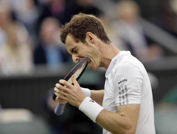 Andy Murray bites on his racket during a frustrating moment against Kevin Anderson on Centre Court. Picture: Ian Rutherford