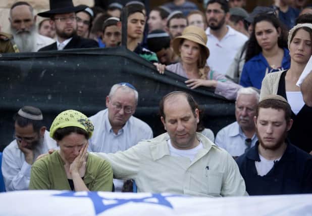 Avi and Rachel Fraenkel attend the funeral of their son, Naftali. His body was discovered on Monday night. Picture: AP