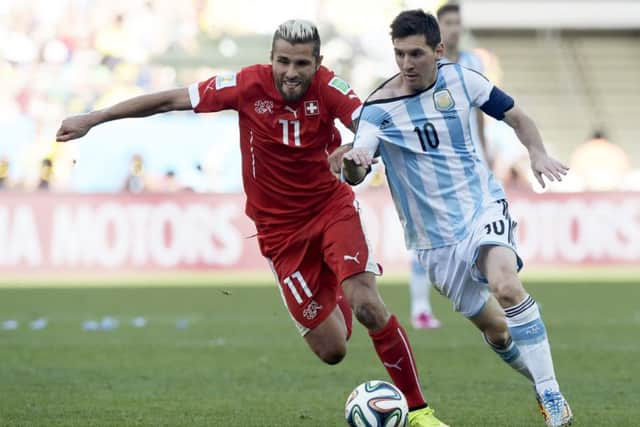 Argentina's forward and captain Lionel Messi and Switzerland's midfielder Valon Behrami vie for the ball. Picture: Getty