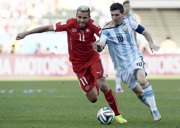 Argentina's forward and captain Lionel Messi and Switzerland's midfielder Valon Behrami vie for the ball. Picture: Getty