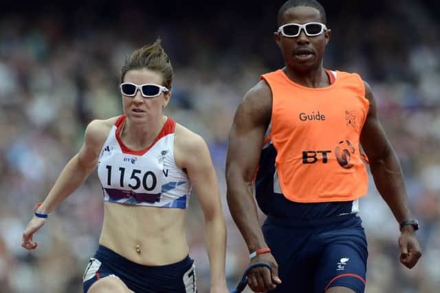 Libby Clegg runs with her guide Mikail Huggins in the 100m event during the London 2012 Paralympics. Picture: AFP/Getty