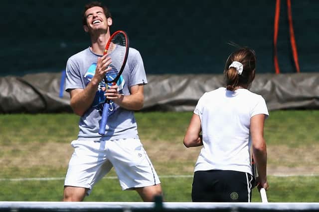 Defending champion Andy Murray jokes with coach Amelie Mauresmo during a practice session ahead. Picture: Getty