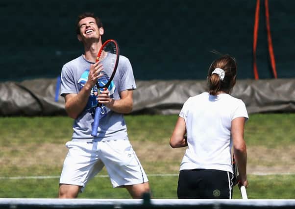 Defending champion Andy Murray jokes with coach Amelie Mauresmo during a practice session ahead. Picture: Getty