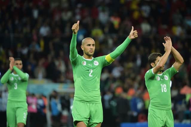 Captain Madjid Bougherra salutes the supporters after their last-16 defeat by Germany. Picture: Getty