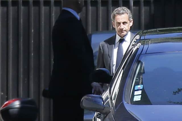 Nicolas Sarkozy leaves his Paris apartment after being informed he is under formal investigation. Picture: Reuters