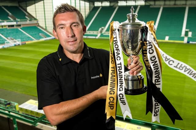 New Hibernian manager Alan Stubbs with the Petrofac Training Cup ahead of the draw. Picture: SNS