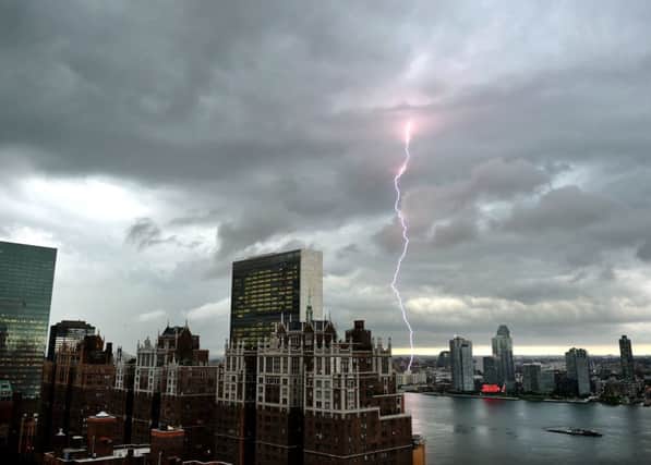 Lightning strikes over the East River and the Empire State building in New York as  the storm nears. Picture: AFP