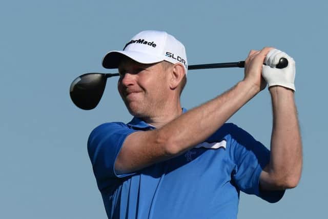 Stephen Gallacher drives off at the 13th during his round of 66 yesterday. Picture: Getty
