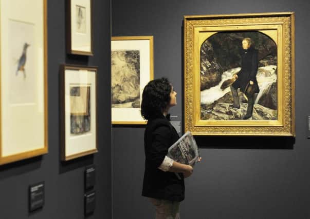 A visitor looks at a portrait of John Ruskin, dated 1854, by John Everett Millais, which sits alongside works by Ruskin. Picture: Phil Wilkinson