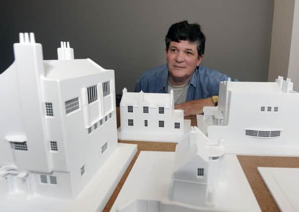 Brian Gallagher, specialist modelmaker, finalizes the display of his specially-commissioned Charles Rennie Mackintosh architectural models. Picture: John Devlin