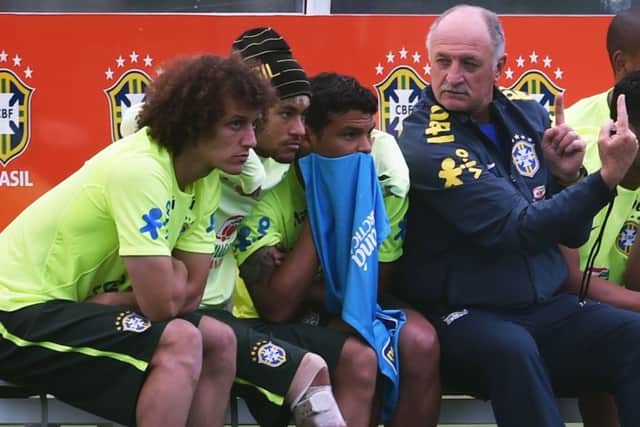 Luiz Felipe Scolari, right, talks tactics with David Luiz, Neymar and Thiago Silva during a training session. Picture: Getty