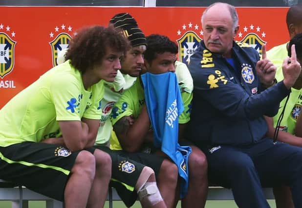 Luiz Felipe Scolari, right, talks tactics with David Luiz, Neymar and Thiago Silva during a training session. Picture: Getty