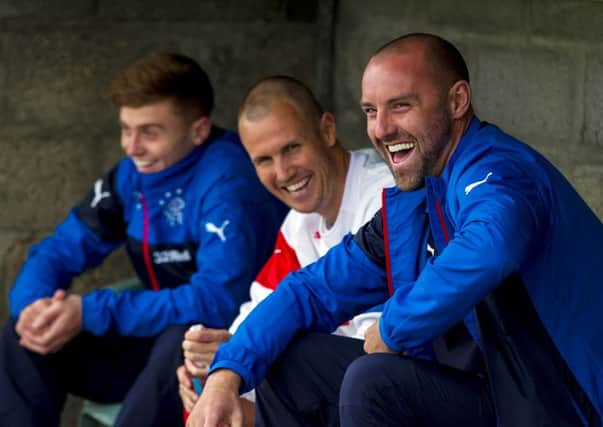 Rangers' Lewis Macleod (left) and Kris Boyd watch on as Kenny Miller (centre) prepares to make his 3rd debut for the club. Picture: SNS