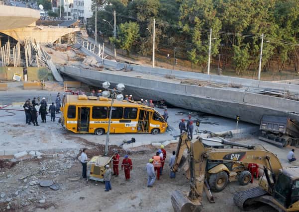 A bus sits damaged next to a bridge after it collapsed in Belo Horizonte, Brazil. Picture: AP