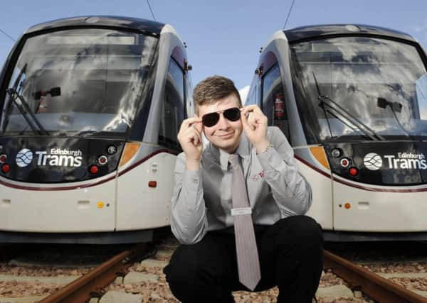 Dale Buchanan, aka Tram Cruise, poses with two Edinburgh Trams. Picture: Greg Macvean