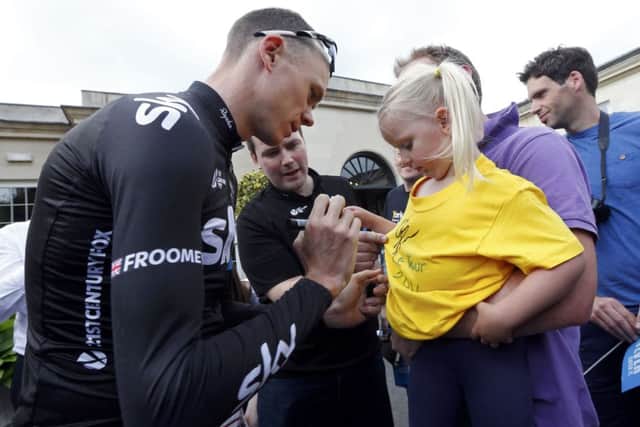 Team Sky rider Christopher Froome of Britain signs an autograph before a training session for the Tour de France cycling. Picture: Reuters