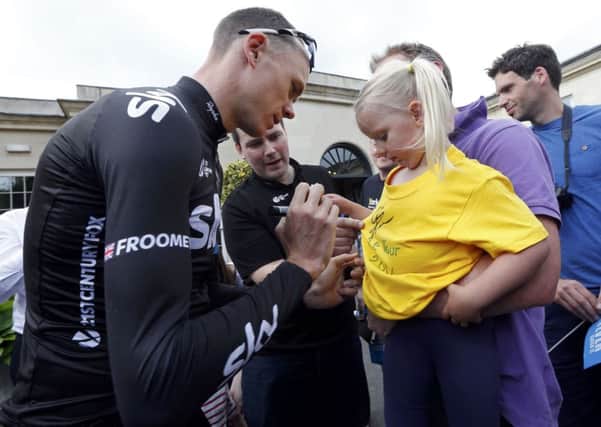 Team Sky rider Christopher Froome of Britain signs an autograph before a training session for the Tour de France cycling. Picture: Reuters