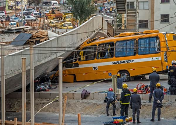 Firefighters and policemen work at the site where several vehicles were crushed by a viaduct that collapsed in Belo Horizonte. Picture: Getty