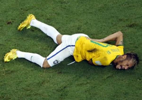 Neymar lies on the ground in pain after Zuniga's challenge. Picture: AP
