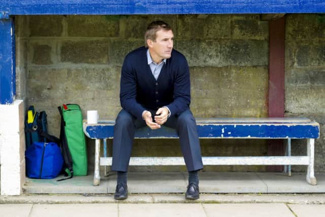 Alan Stubbs sits in the dugout ahead of kick-off. Picture: SNS