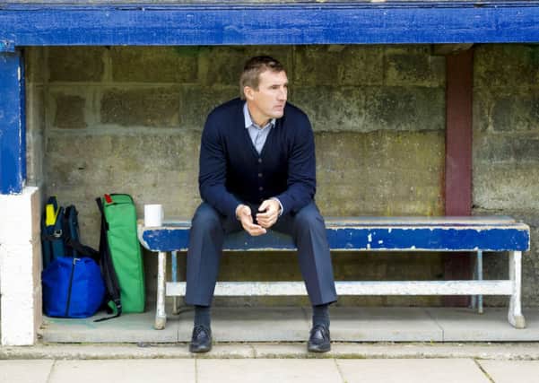 Alan Stubbs sits in the dugout ahead of kick-off. Picture: SNS