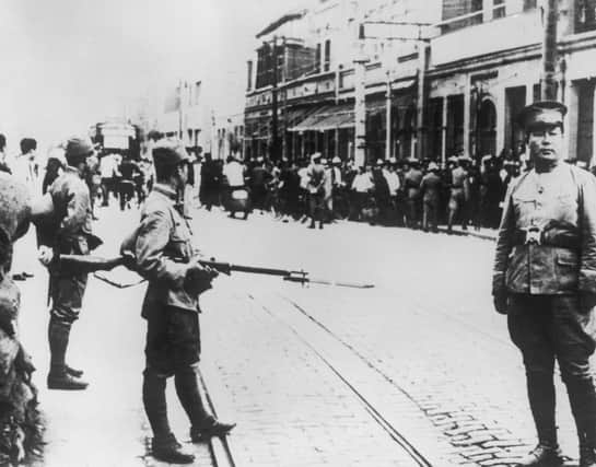 Japanese troops search members of the Chinese population during clashes that marked the start of Sino-Japanese War in 1937. Picture: Getty