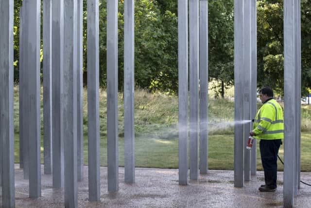 Workers clean the memorial in Hyde Park commemorating the victims of the 7/7 bombings. Picture: Getty.