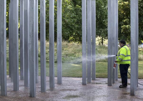 Workers clean the memorial in Hyde Park commemorating the victims of the 7/7 bombings. Picture: Getty.